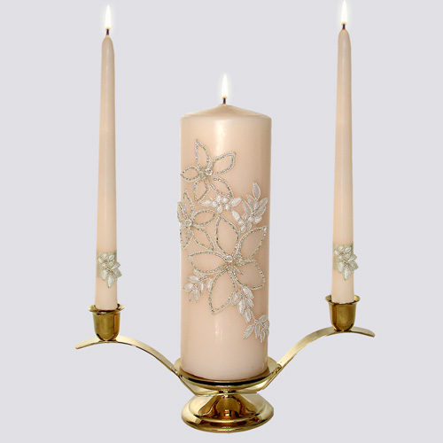 Delicately beaded lily flowers adorn the unity candle while a silk band 