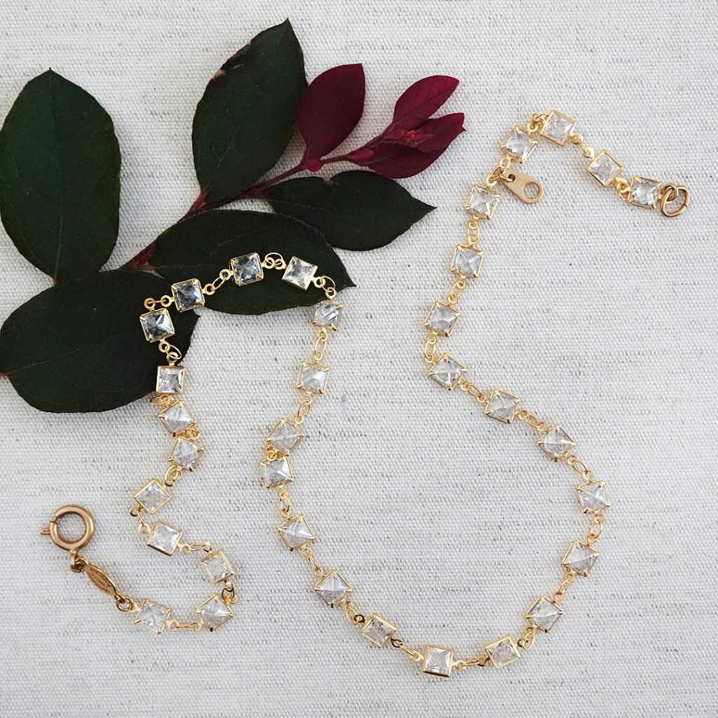 gold link necklace of small bezel set square crystals close together. Bold, yet delicate